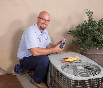 man working on heat pump
